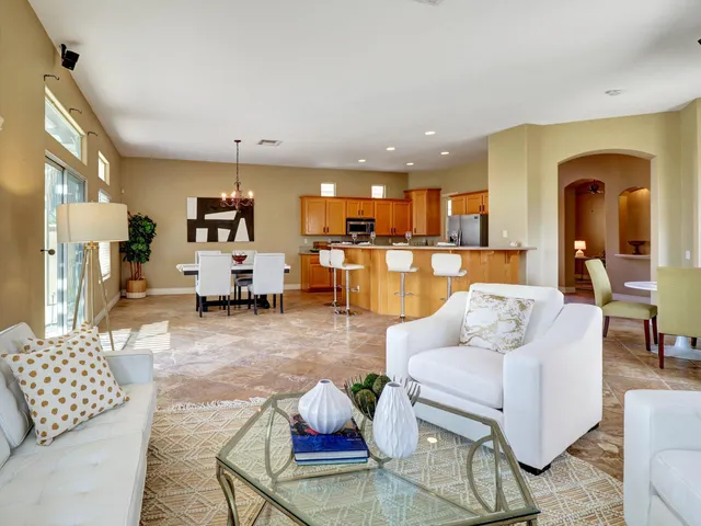 a living room with furniture and kitchen view