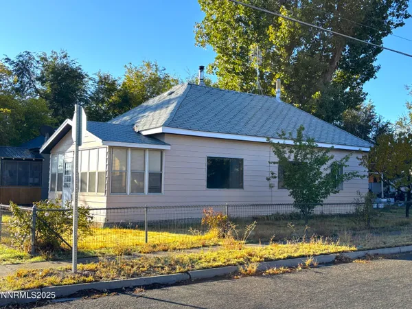 a view of house with garden and swimming pool