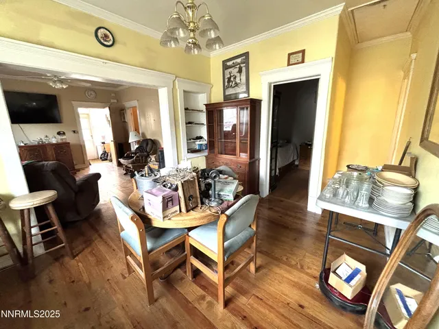 a living room with furniture a dining table and a chandelier