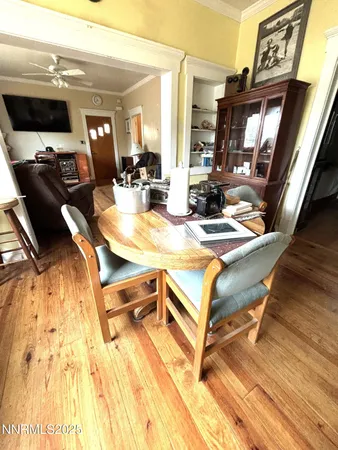 a view of a dining room with furniture and a flat screen tv