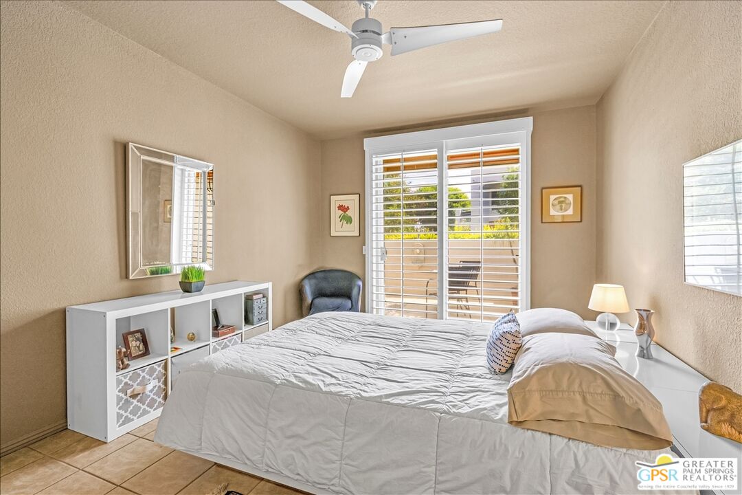 401 El Cielo Road, Unit 227 Palm Springs, CA 92262 - Photo 15 of 45 a bedroom with a bed and a window