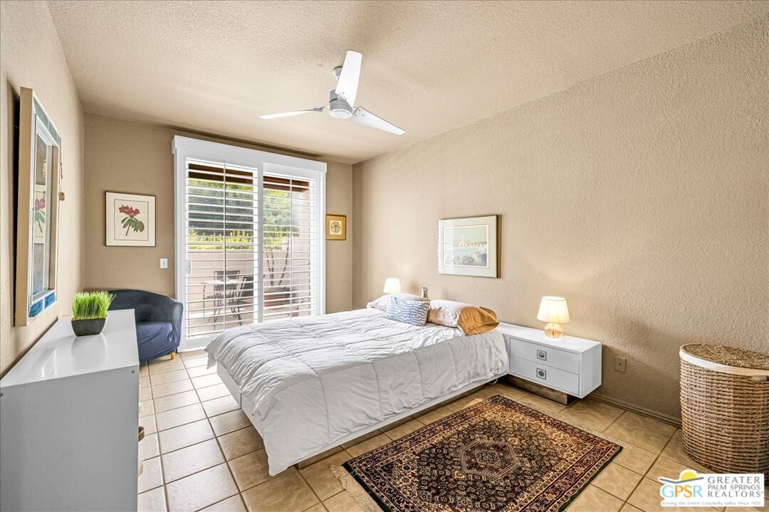 401 El Cielo Road, Unit 227 Palm Springs, CA 92262 - Photo 16 of 43 a bed room with a bed and a couch
