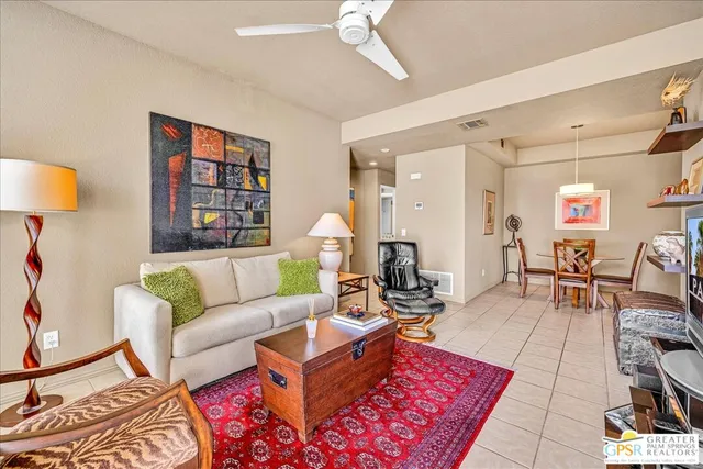 a living room with furniture a rug and a chandelier