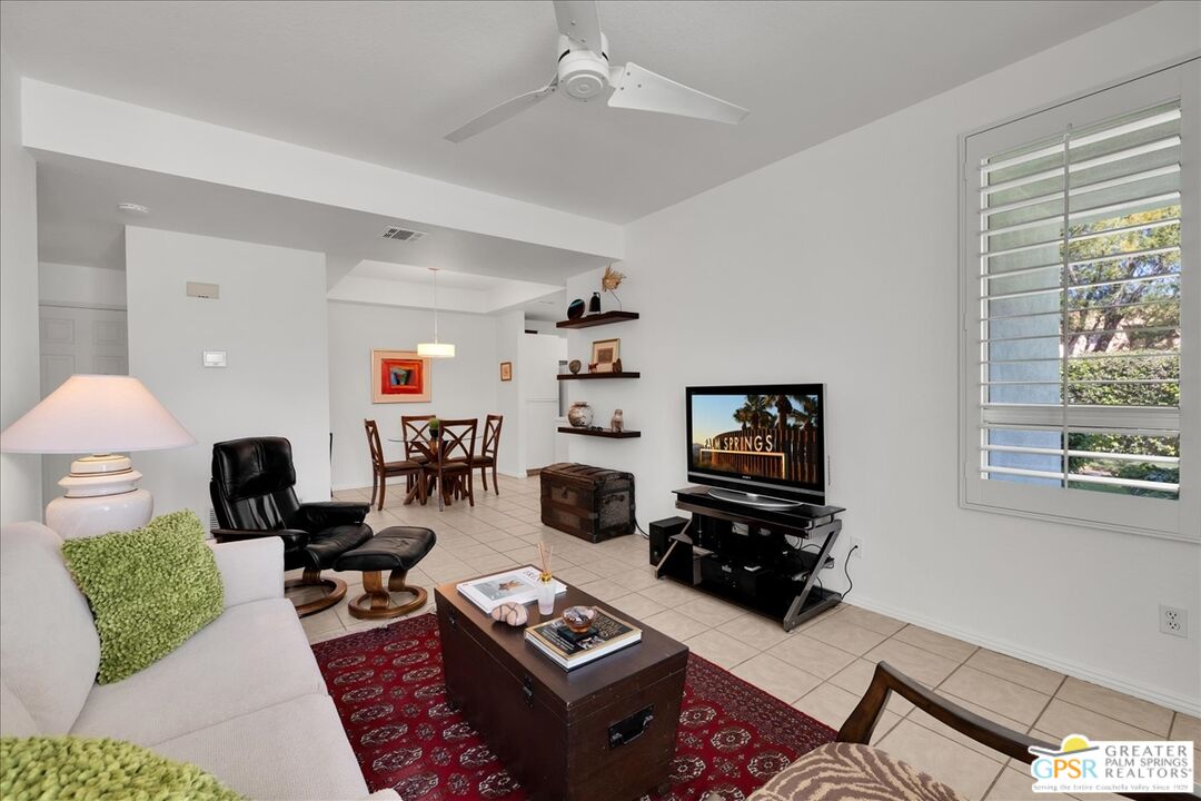 401 El Cielo Road, Unit 227 Palm Springs, CA 92262 - Photo 2 of 43 a living room with furniture and a flat screen tv