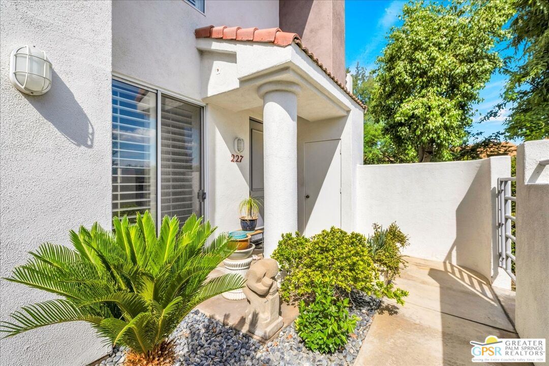 401 El Cielo Road, Unit 227 Palm Springs, CA 92262 - Photo 22 of 43 a front view of a house with a garden
