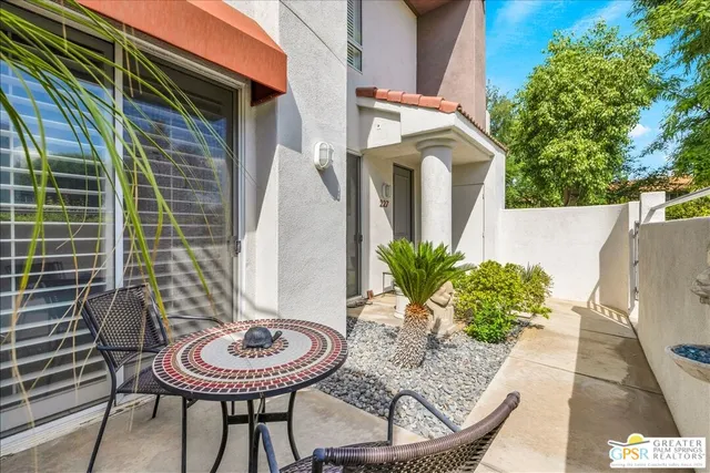 a view of a chair and table in backyard