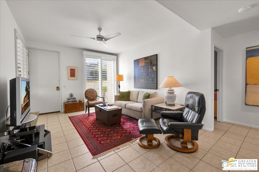 401 El Cielo Road, Unit 227 Palm Springs, CA 92262 - Photo 3 of 43 a living room with furniture a flat screen tv and a window
