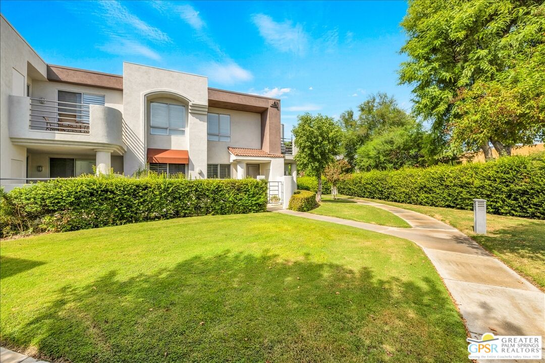 401 El Cielo Road, Unit 227 Palm Springs, CA 92262 - Photo 33 of 45 a front view of a house with a yard
