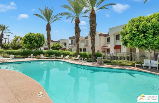 a front view of a house with swimming pool having outdoor seating