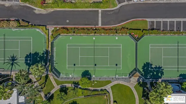 a green field with some trees in front of it