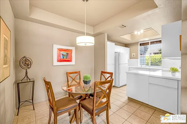a view of a dining room with furniture and a chandelier