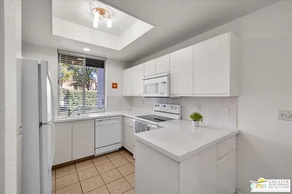 a kitchen with a sink cabinets and window