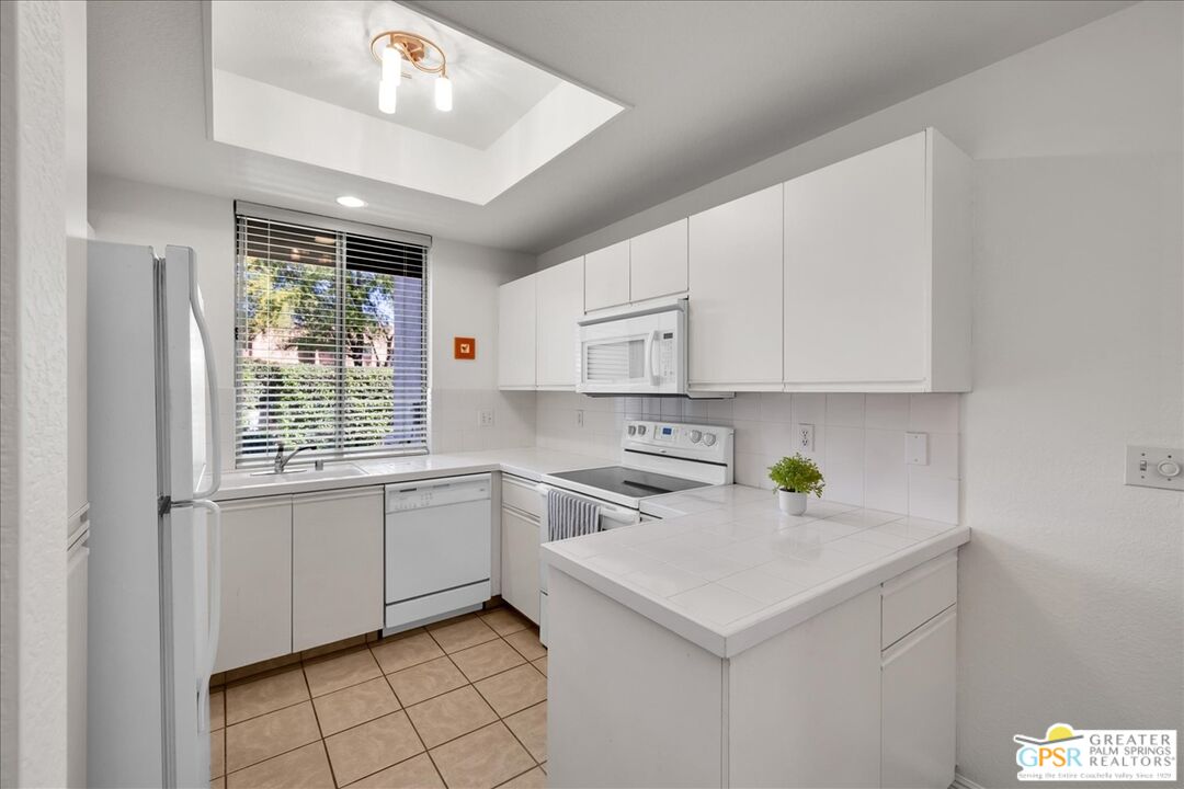 401 El Cielo Road, Unit 227 Palm Springs, CA 92262 - Photo 7 of 43 a kitchen with a sink cabinets and window