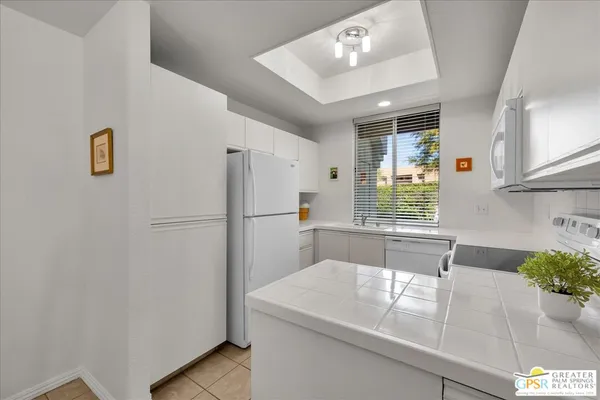 a kitchen with refrigerator and window