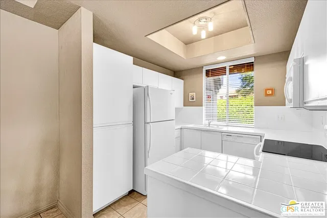 a white refrigerator freezer sitting inside of a kitchen