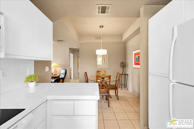 a view of a kitchen with dining table and chairs