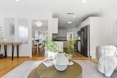 a kitchen with stainless steel appliances kitchen island granite countertop a refrigerator and a sink