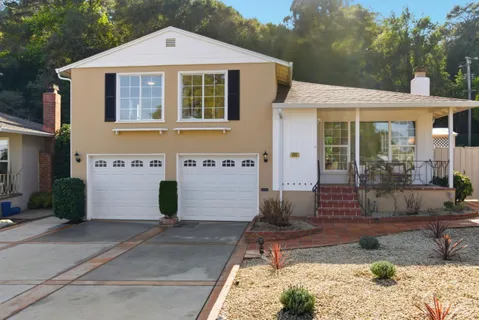 a front view of a house with garden