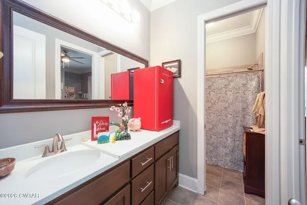 a bathroom with a sink vanity and a mirror