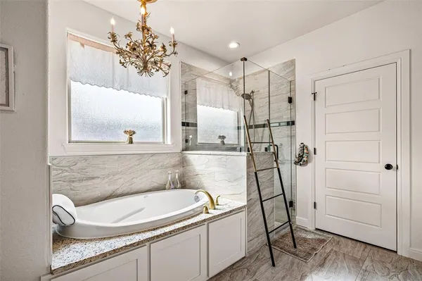 a bathroom with a sink a large mirror and a shower