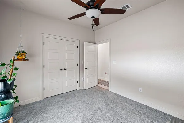 a view of empty room with ceiling fan