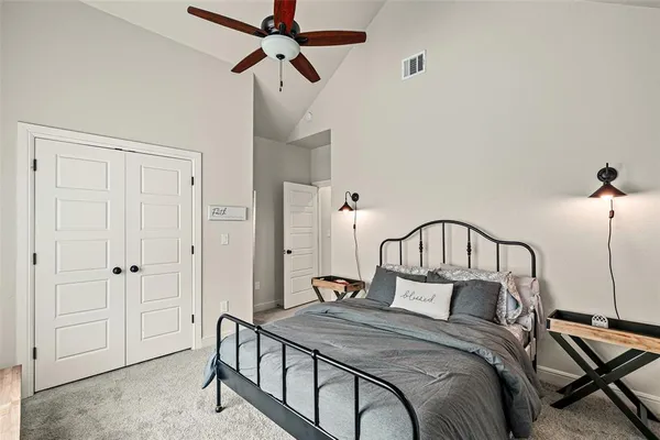 a bedroom with a bed and cabinets
