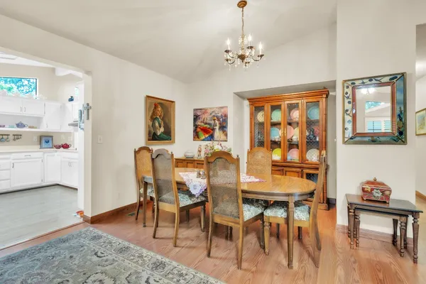 a view of a dining room with furniture and wooden floor