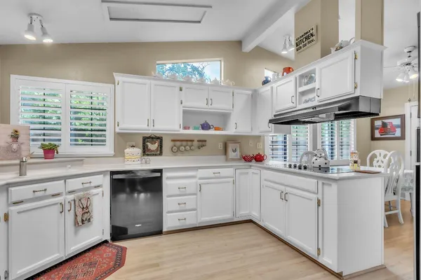 a kitchen with cabinets a sink and appliances