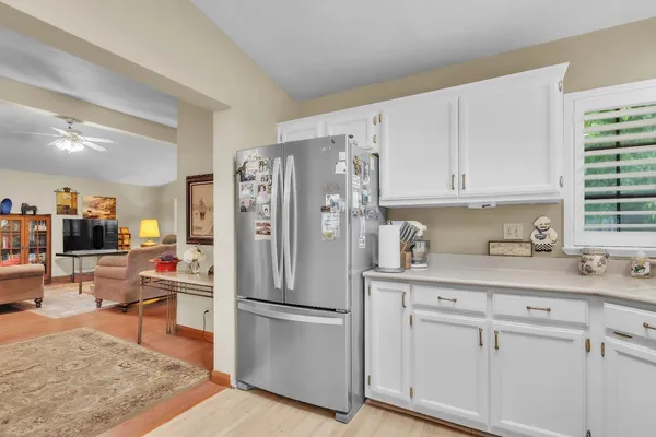 a kitchen with stainless steel appliances granite countertop a refrigerator sink and cabinets