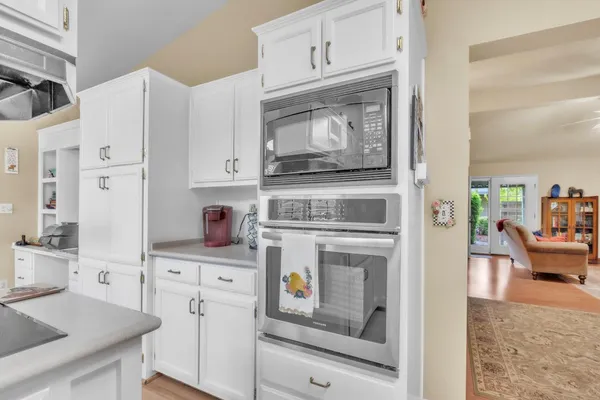 a kitchen with stainless steel appliances white cabinets and a stove