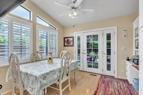a dining room with furniture wooden floor a rug and a chandelier