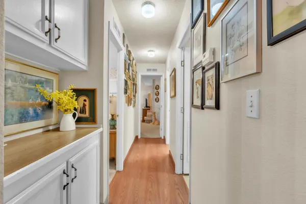 a view of a hallway view with wooden floor and staircase