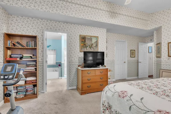 a bedroom with a bed and a television