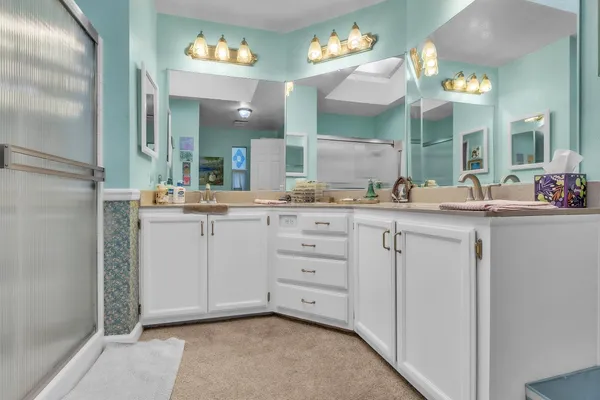 a bathroom with a sink vanity and mirror