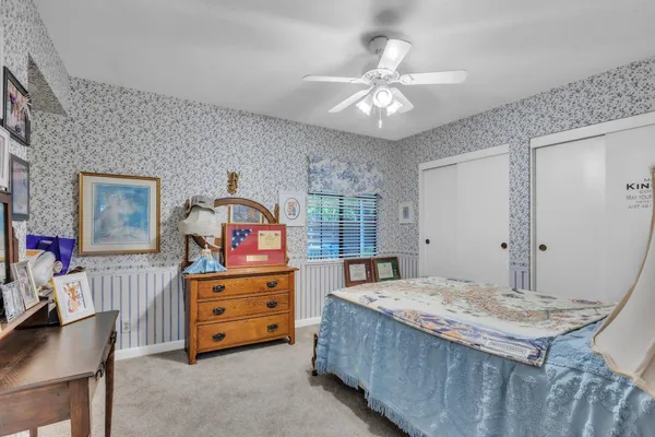 a bedroom with a bed and a dresser in it