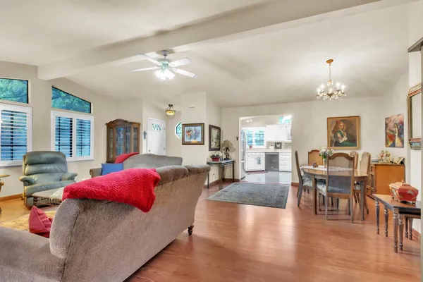 a living room with furniture and a chandelier
