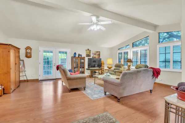 a living room with furniture and large windows