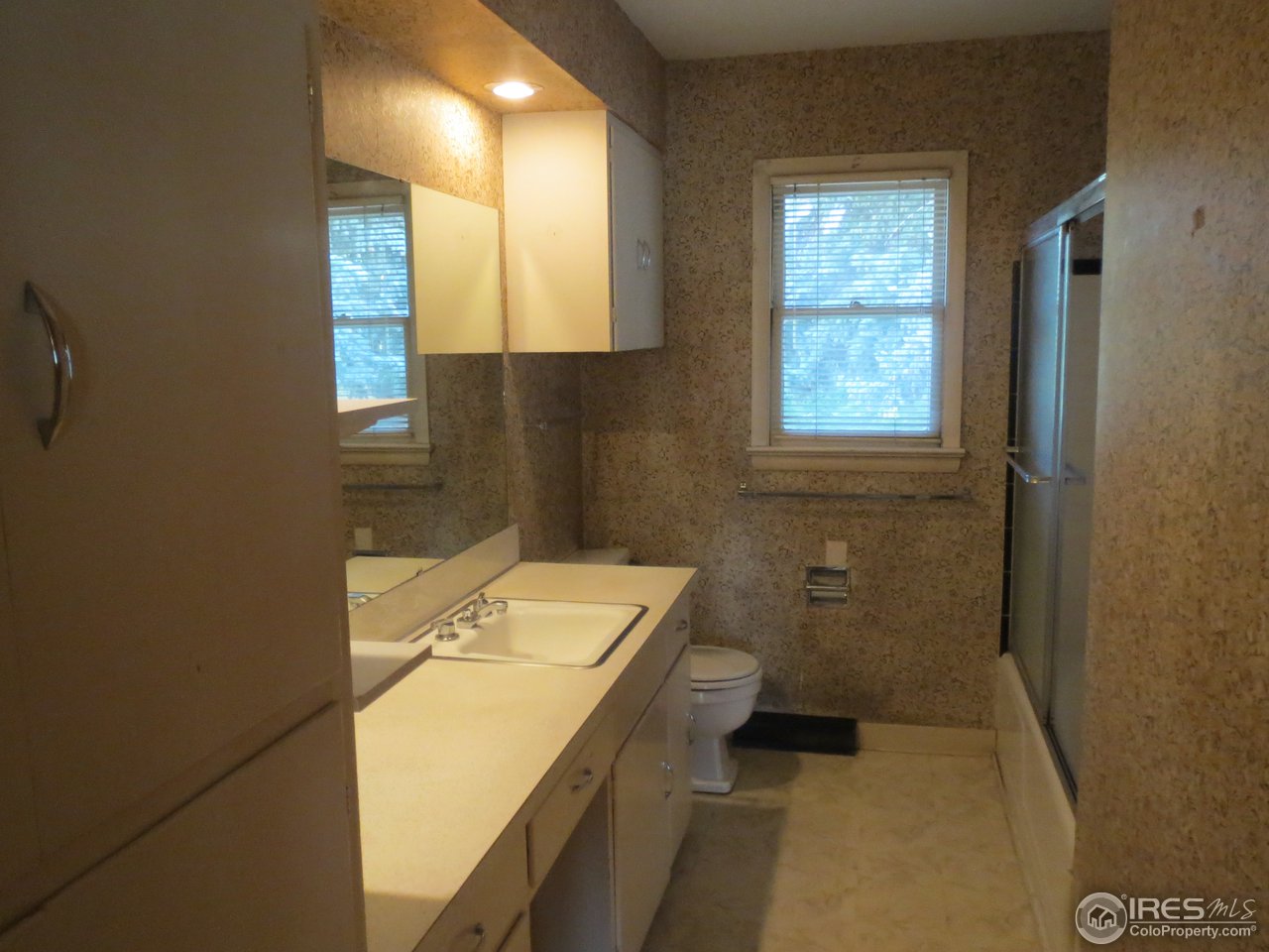 723 East Prospect Road Fort Collins, CO 80525 - Photo 11 of 18 a bathroom with a granite countertop sink a toilet and shower