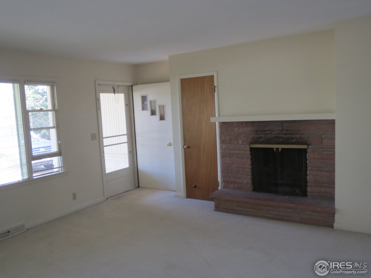723 East Prospect Road Fort Collins, CO 80525 - Photo 2 of 18 an empty room with windows and fireplace