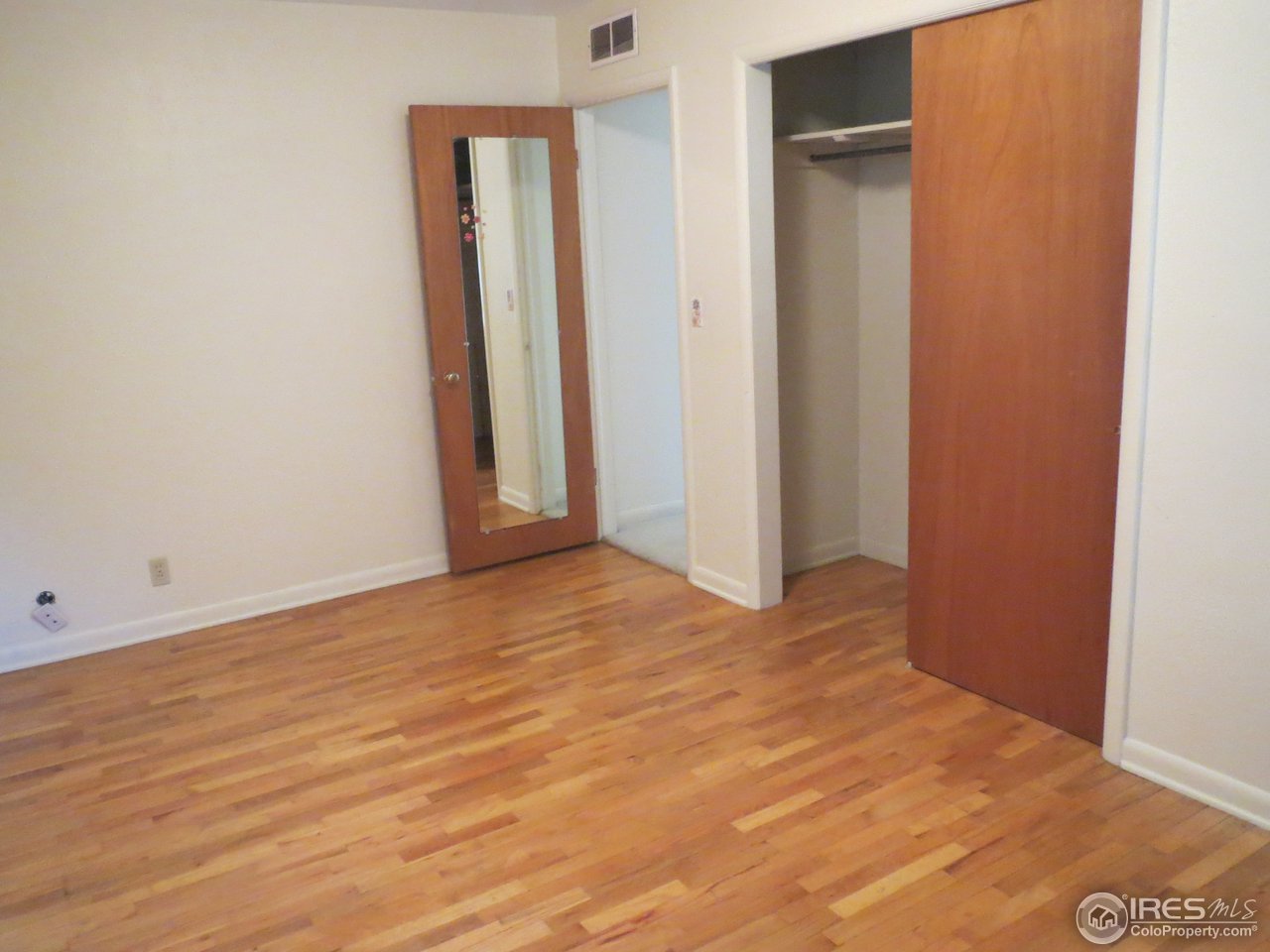 723 East Prospect Road Fort Collins, CO 80525 - Photo 9 of 18 an empty room with wooden floor and closet