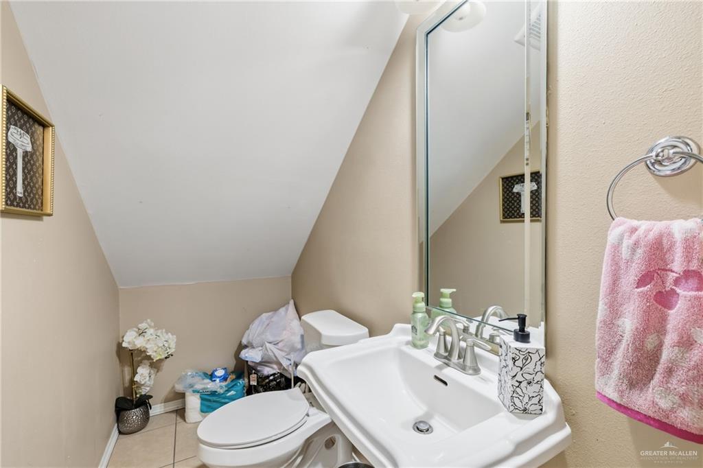 3005 South L Street, Unit 3 McAllen, TX 78503 - Photo 12 of 14 a bathroom with a sink toilet and mirror
