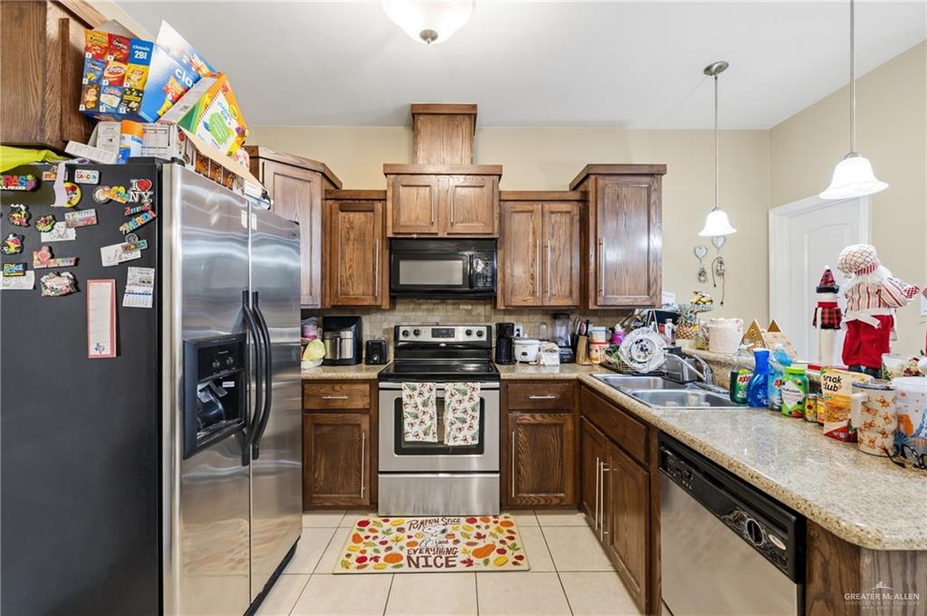 3005 South L Street, Unit 3 McAllen, TX 78503 - Photo 5 of 14 a kitchen with stainless steel appliances granite countertop a sink stove and refrigerator