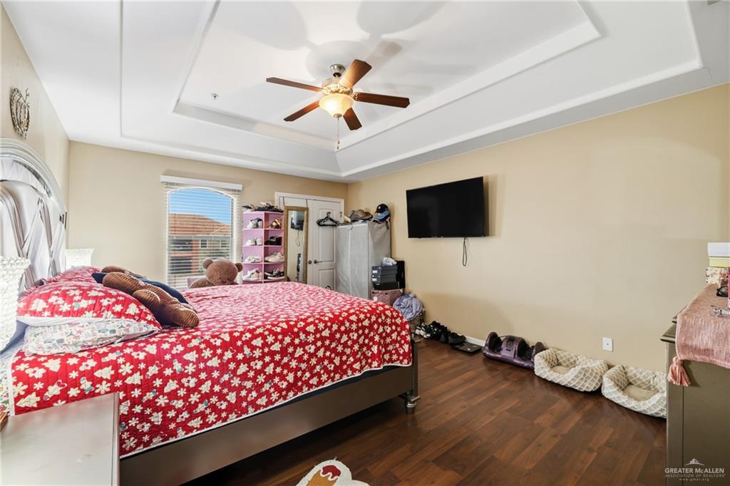 3005 South L Street, Unit 3 McAllen, TX 78503 - Photo 8 of 14 a bedroom with a bed and a flat screen tv