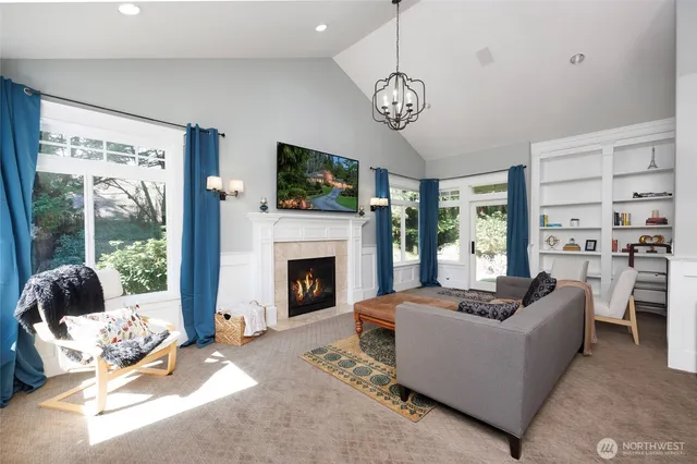 a living room with furniture a fireplace and a flat screen tv