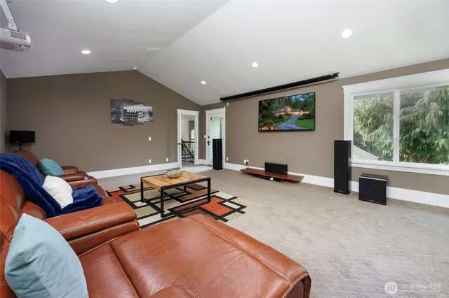a living room with furniture a flat screen tv and a large window