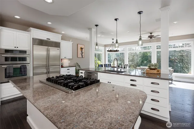 a kitchen with stainless steel appliances granite countertop a sink stove and refrigerator