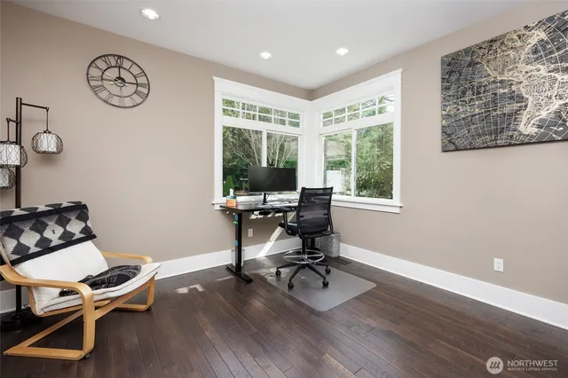 a view of a workspace with furniture and a window