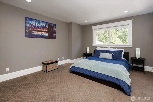 a spacious bedroom with a bed and a window