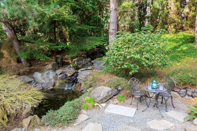 a view of a table and chairs in a garden