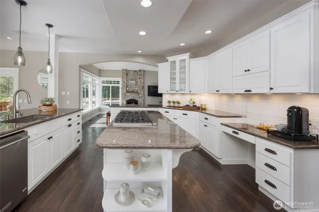 a kitchen with a sink stove and cabinets